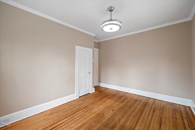 unfurnished room with crown molding and hardwood / wood-style floors