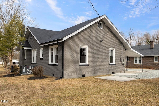 view of side of property featuring a yard and a patio