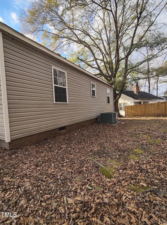 view of side of home featuring central AC