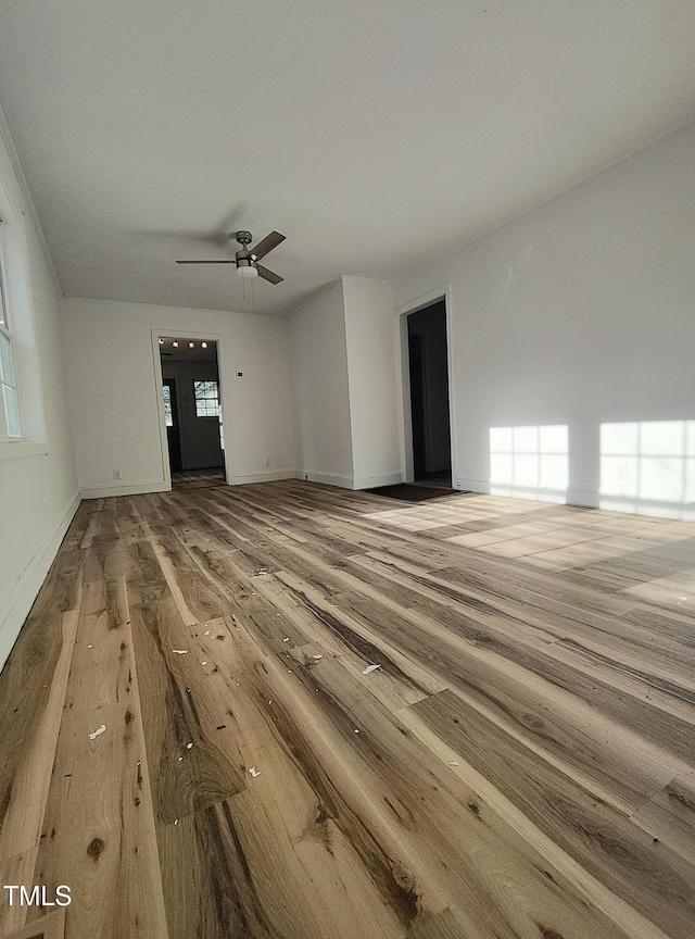 unfurnished living room featuring hardwood / wood-style floors and ceiling fan