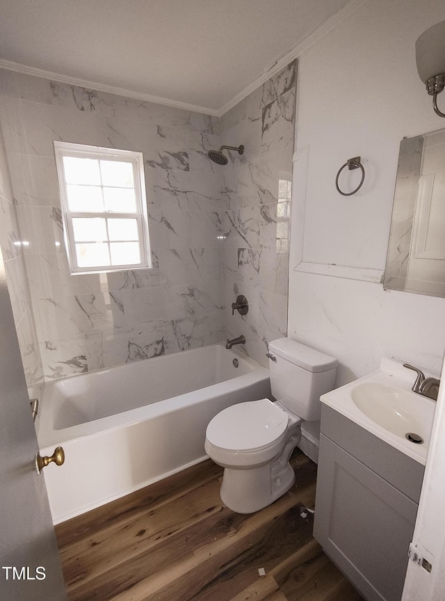 full bathroom with toilet, crown molding, vanity, tiled shower / bath combo, and hardwood / wood-style flooring