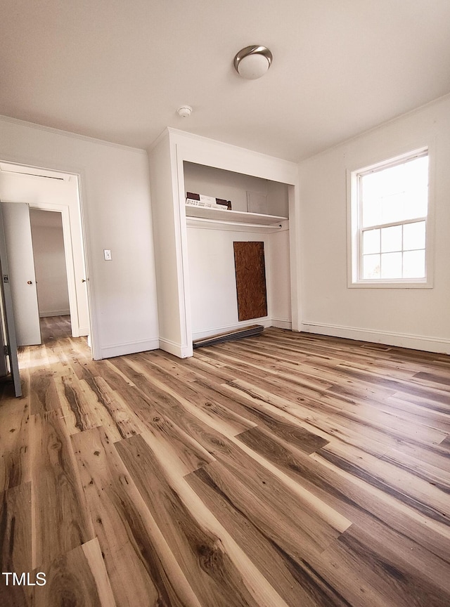 unfurnished bedroom featuring hardwood / wood-style floors and a closet