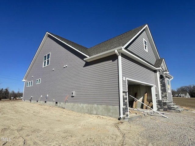 view of side of home featuring a garage