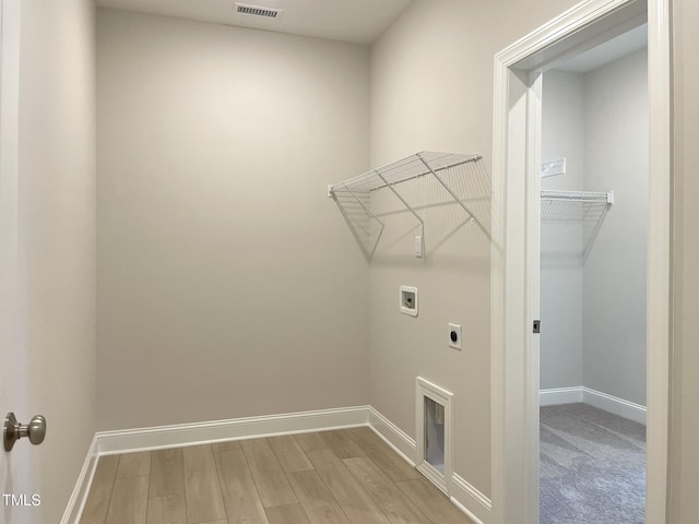 82 N Stagecoach Dr, Wendell, NC 27591 - washroom featuring washer hookup, hookup for an electric dryer, and wood finished floors