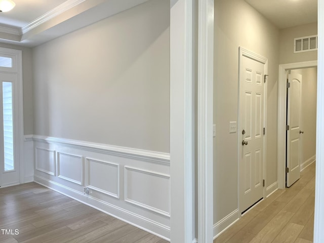 82 N Stagecoach Dr, Wendell, NC 27591 - hall featuring light wood-style flooring, ornamental molding, a wainscoted wall, and a decorative wall