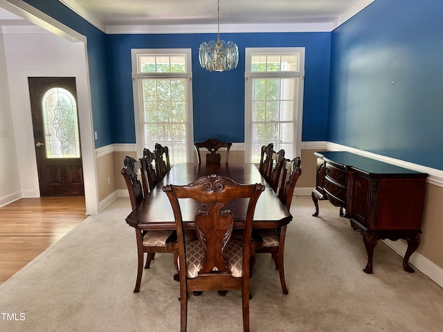 2934 Appaloosa Ct, Graham, NC 27253 - dining area featuring a chandelier, crown molding, baseboards, and light carpet