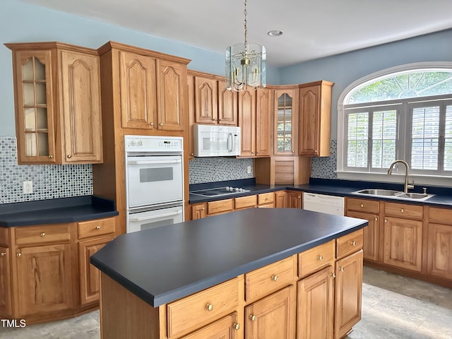 2934 Appaloosa Ct, Graham, NC 27253 - kitchen featuring white appliances, a sink, dark countertops, a kitchen island, and a chandelier