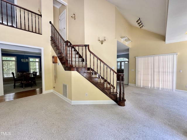 2934 Appaloosa Ct, Graham, NC 27253 - stairway featuring carpet, high vaulted ceiling, and baseboards