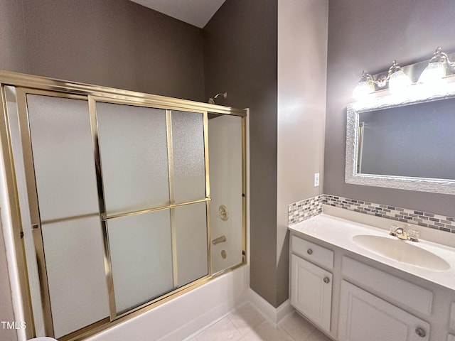 2934 Appaloosa Ct, Graham, NC 27253 - bathroom featuring vanity, combined bath / shower with glass door, tile patterned flooring, decorative backsplash, and baseboards