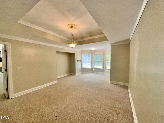 2934 Appaloosa Ct, Graham, NC 27253 - empty room featuring a raised ceiling, crown molding, carpet flooring, and baseboards