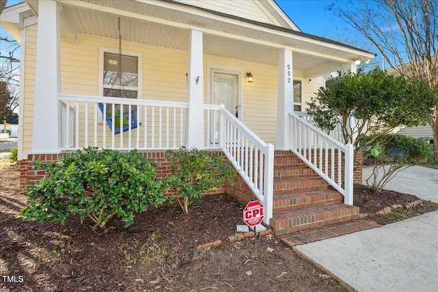 property entrance with covered porch