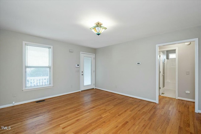 empty room with light hardwood / wood-style flooring