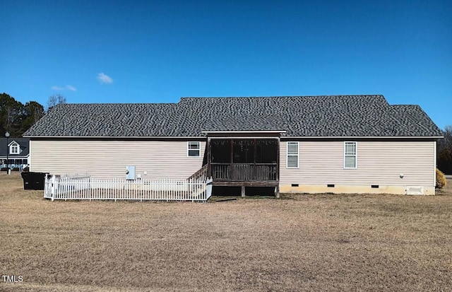 rear view of property featuring a lawn