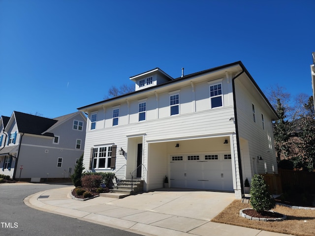 view of front of property with a garage and concrete driveway