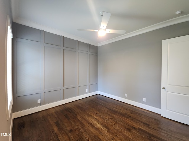 unfurnished room with a decorative wall, a ceiling fan, visible vents, ornamental molding, and dark wood-style floors