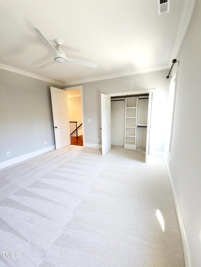 unfurnished bedroom featuring visible vents, ornamental molding, and light colored carpet