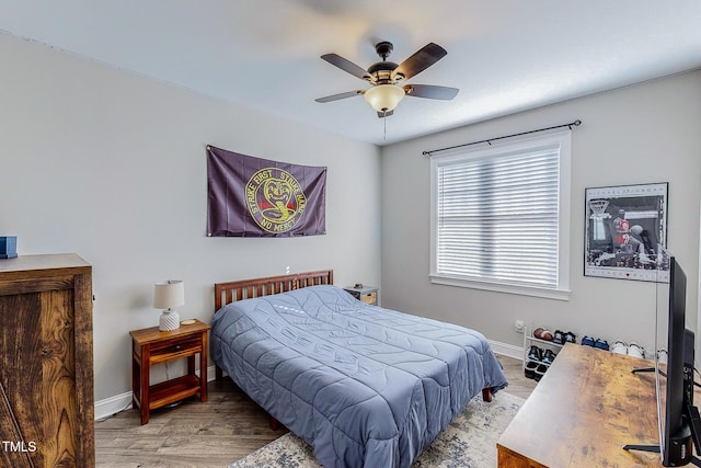 bedroom with ceiling fan and wood-type flooring