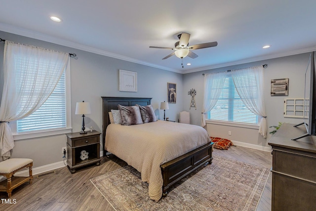 bedroom featuring hardwood / wood-style flooring, ornamental molding, and ceiling fan