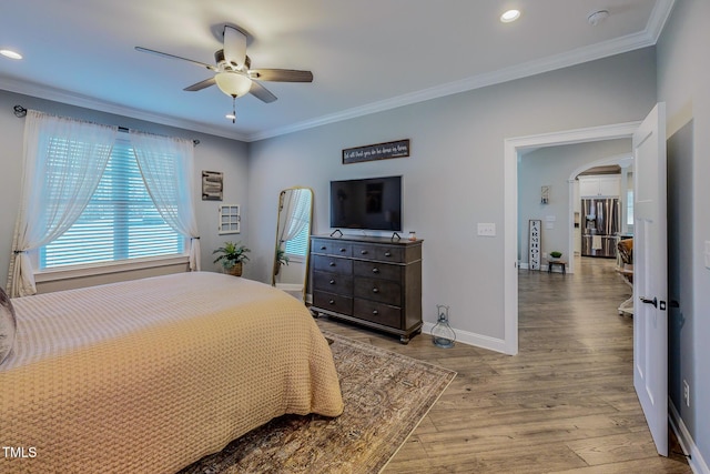 bedroom featuring hardwood / wood-style flooring, ceiling fan, and ornamental molding