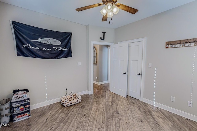 bedroom with ceiling fan and light hardwood / wood-style floors