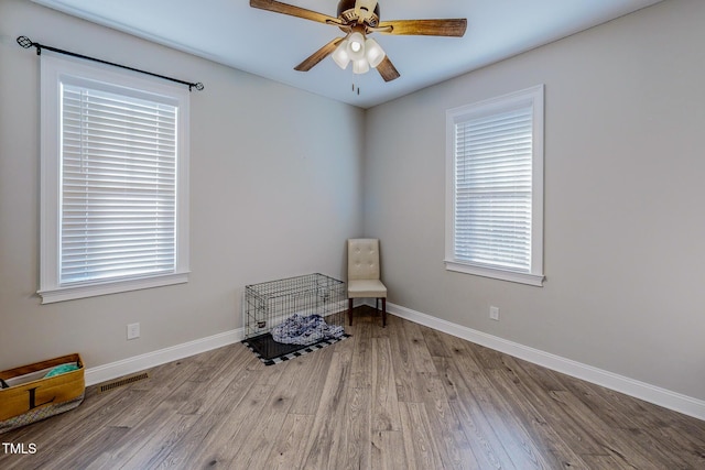 living area featuring ceiling fan and light wood-type flooring