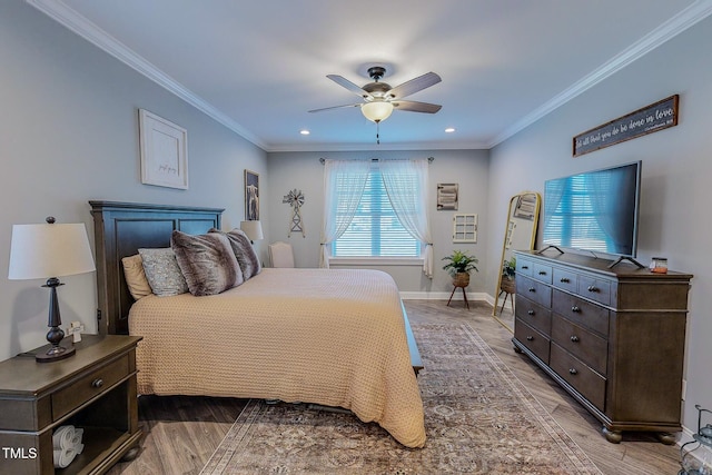 bedroom with ceiling fan, ornamental molding, and hardwood / wood-style floors