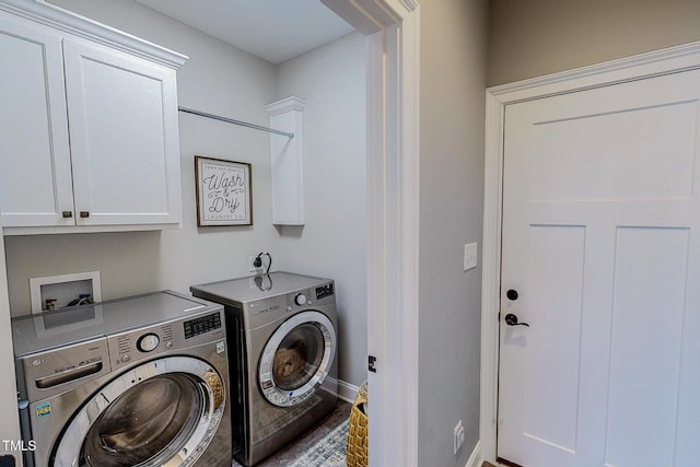 washroom featuring cabinets and washing machine and clothes dryer