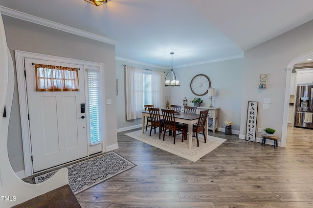 foyer entrance featuring an inviting chandelier, ornamental molding, and hardwood / wood-style floors