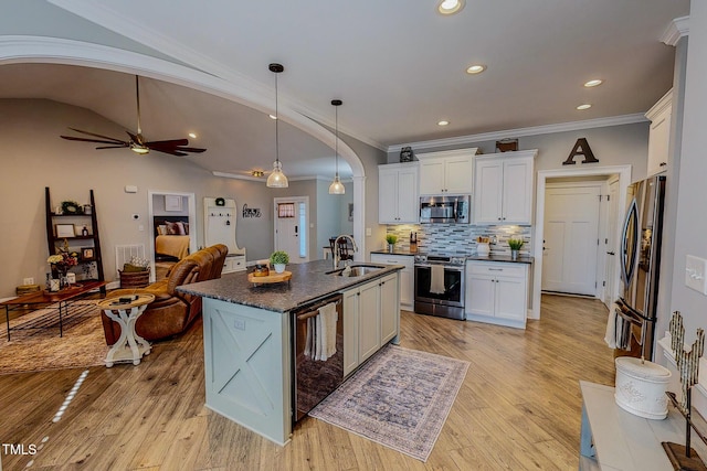 kitchen with sink, white cabinetry, a center island with sink, pendant lighting, and stainless steel appliances