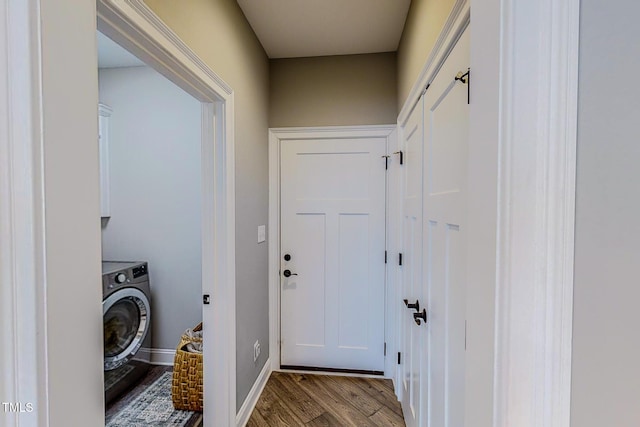 clothes washing area featuring cabinets, washer / dryer, and light hardwood / wood-style floors