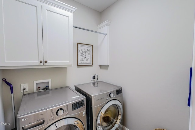 washroom with washing machine and dryer and cabinets