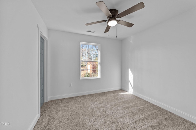 carpeted spare room featuring ceiling fan