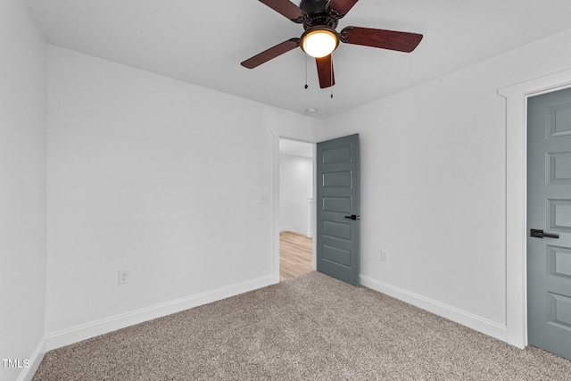 unfurnished bedroom featuring light colored carpet and ceiling fan