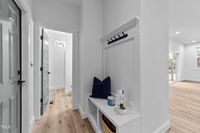 mudroom with light hardwood / wood-style flooring