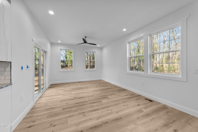 interior space with ceiling fan and light hardwood / wood-style floors