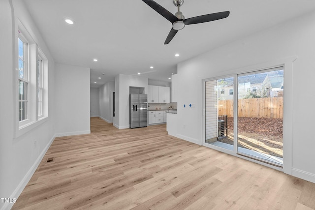 unfurnished living room featuring light hardwood / wood-style floors and ceiling fan