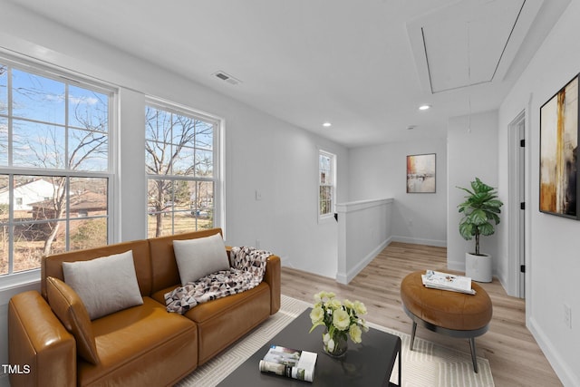 living room featuring plenty of natural light and light hardwood / wood-style floors