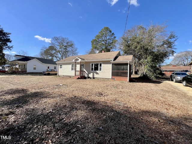 rear view of property with a sunroom