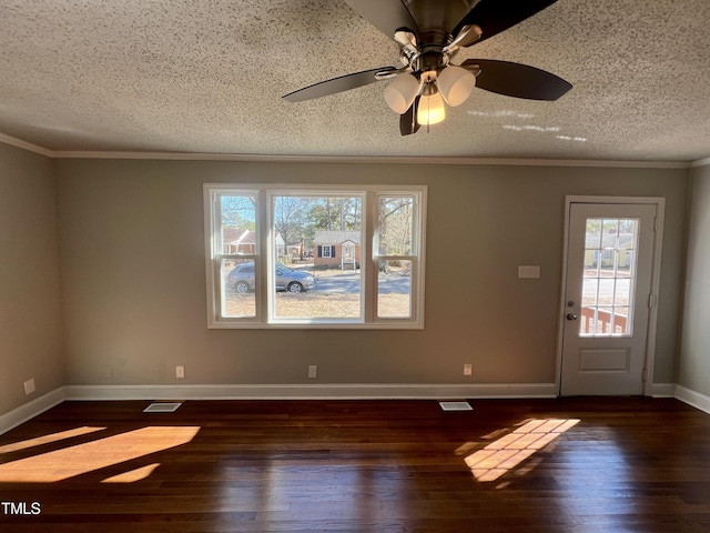 interior space with ornamental molding, dark hardwood / wood-style floors, ceiling fan, and a textured ceiling