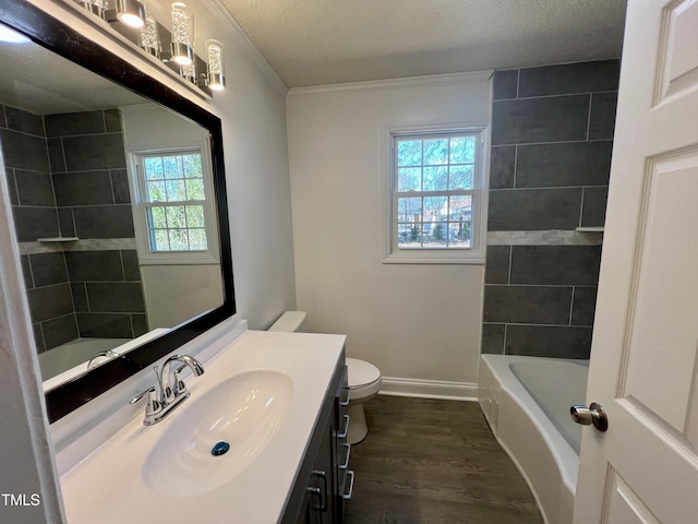 full bathroom with crown molding, vanity, wood-type flooring, a textured ceiling, and toilet