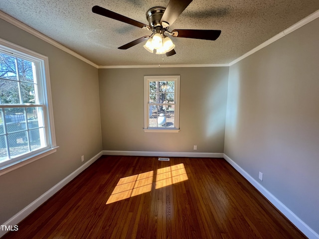 empty room with dark wood-type flooring, ornamental molding, and a textured ceiling