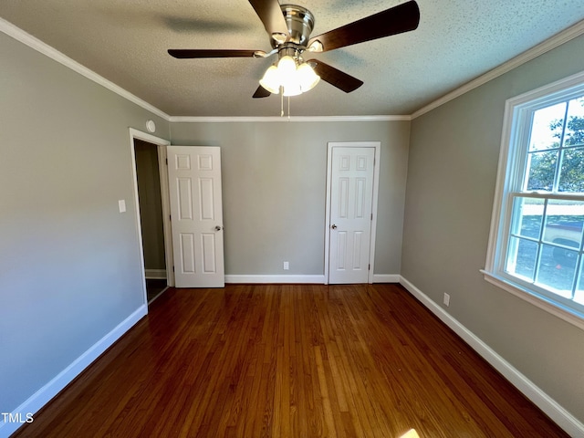 unfurnished bedroom with dark hardwood / wood-style flooring, ceiling fan, crown molding, and a textured ceiling