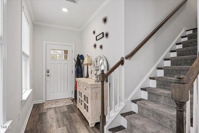 foyer featuring dark wood finished floors, stairway, baseboards, and ornamental molding