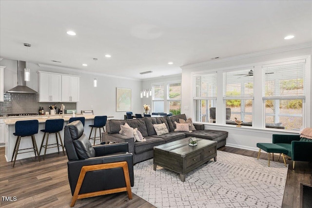 living area featuring dark wood finished floors, recessed lighting, and crown molding