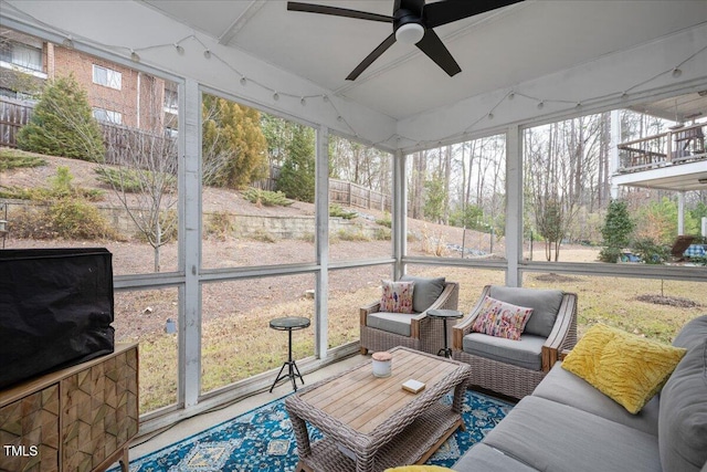 sunroom / solarium with a ceiling fan