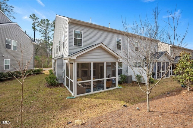 rear view of house featuring central AC, a yard, and a sunroom