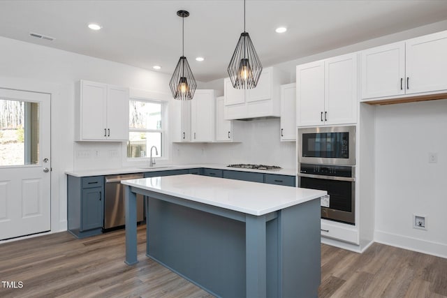 kitchen with stainless steel appliances and white cabinets