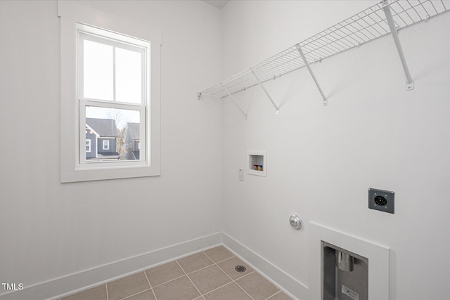 clothes washing area featuring laundry area, baseboards, gas dryer hookup, washer hookup, and electric dryer hookup