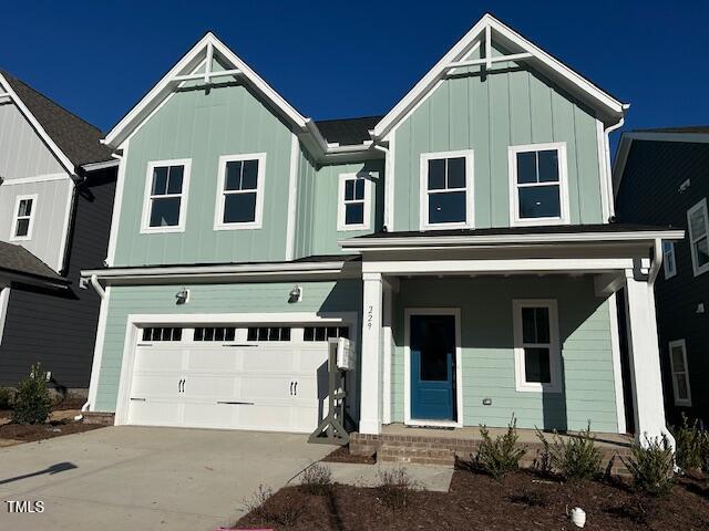 view of front of property featuring driveway, an attached garage, and board and batten siding