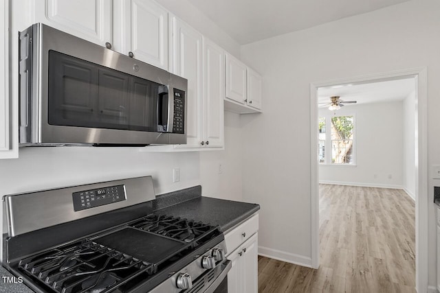 kitchen with white cabinetry, appliances with stainless steel finishes, ceiling fan, and light hardwood / wood-style flooring